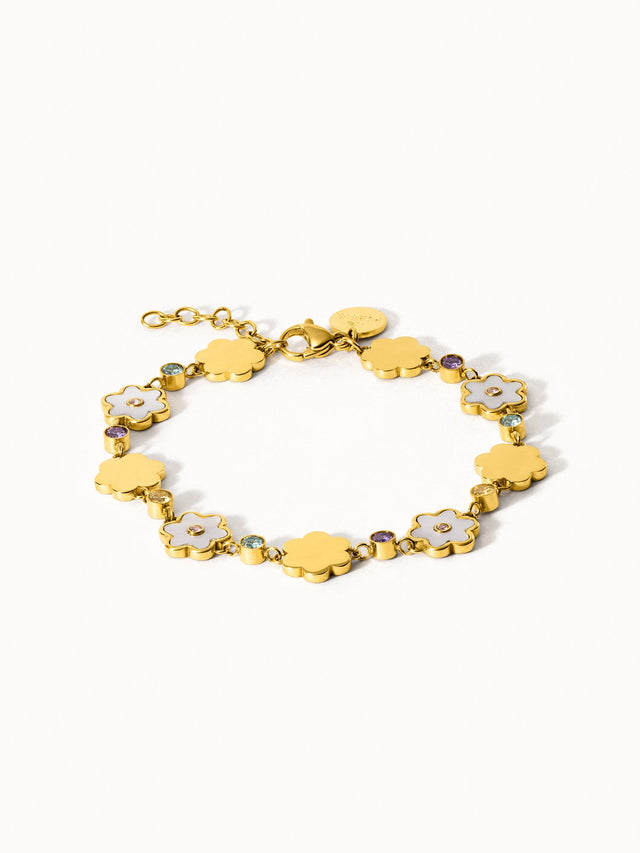 Goldenes Armband mit blütenförmigen Anhängern und funkelnden Details von PURELEI.