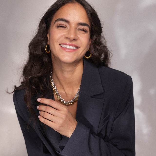 Silberne Kette und Creolen, strahlendes Lächeln, PURELEI inspiriert von Eleganz und Lebensfreude.