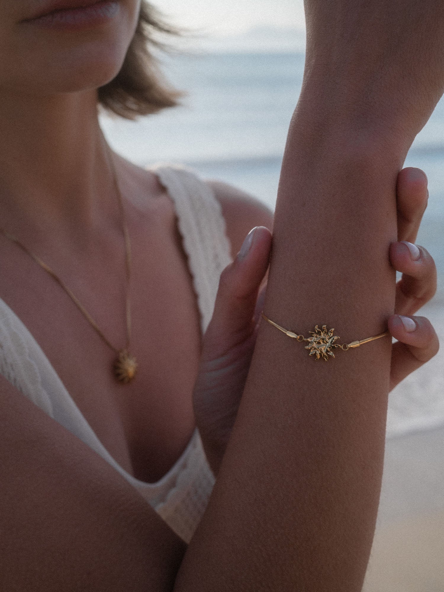 Silbernes Armband mit Sonnenmotiv, getragen am Handgelenk, PURELEI inspiriert von Aloha-Vibes.