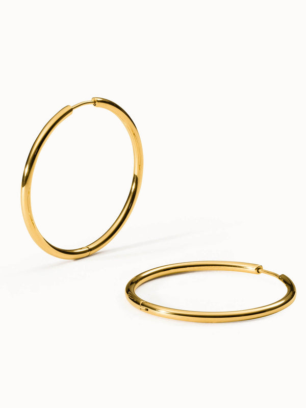 Goldene Creolen von PURELEI mit elegantem, schlichtem Design, strahlend und modern.