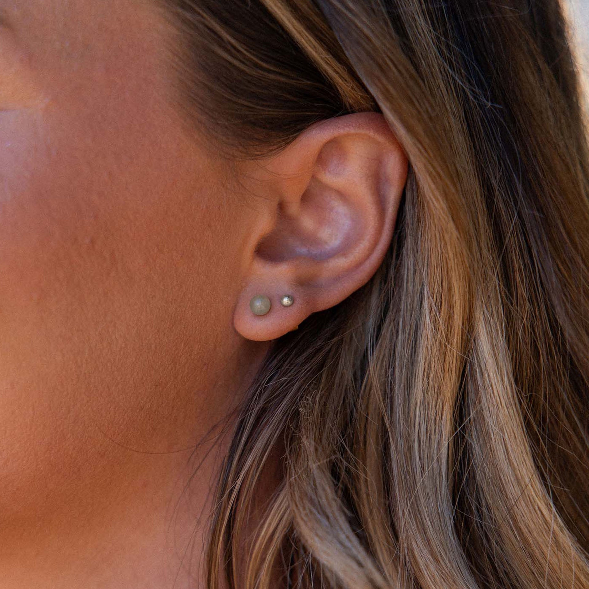 Aventurine Ohrringe von PURELEI, vergoldete Ohrstecker mit grünem Aventurin, fein und elegant am Ohr getragen.