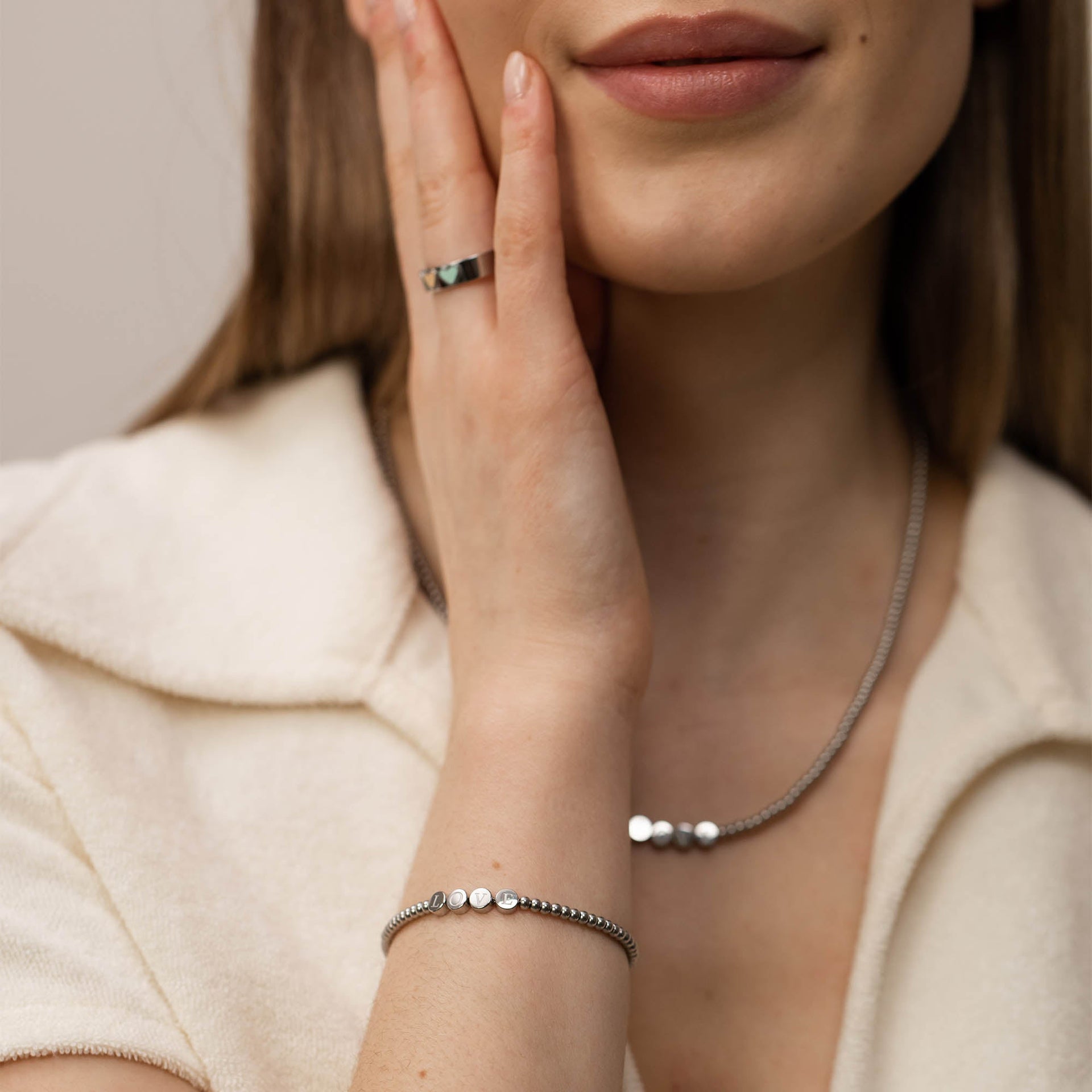 Silberne PURELEI Kette und Armband mit glänzenden Details, elegant und modern getragen.